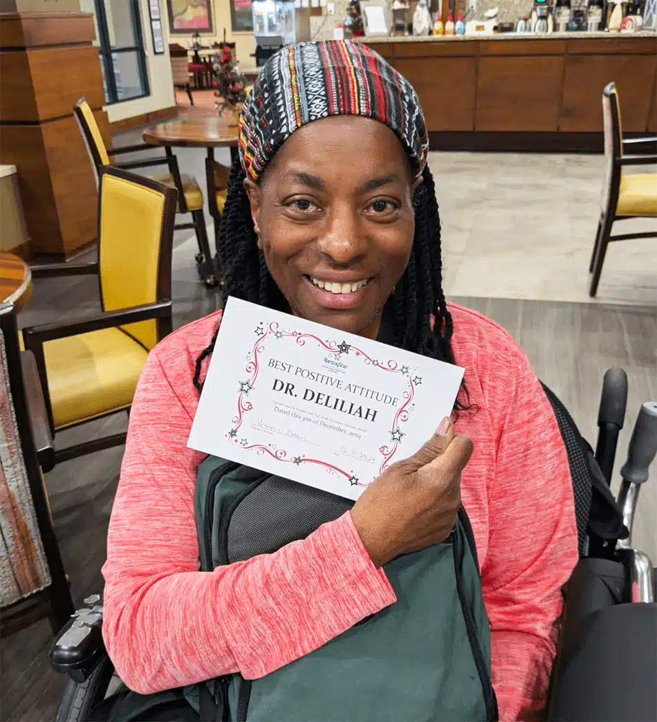 Resident holding a certificate for best positive attitude