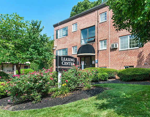Exterior view of a leasing center with greenery