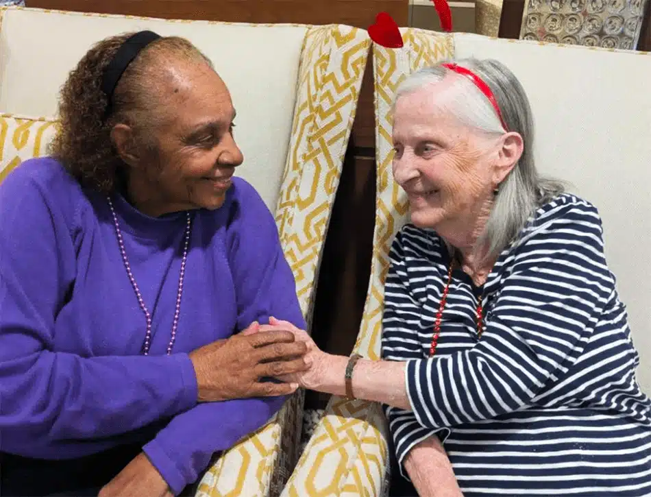 Two residents interacting and smiling in a common area