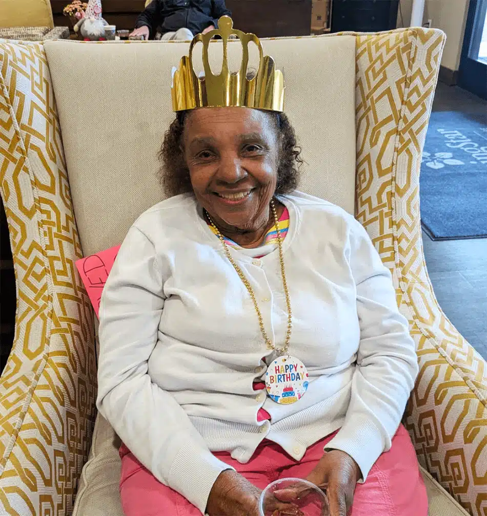 Resident celebrating her birthday in a cozy chair