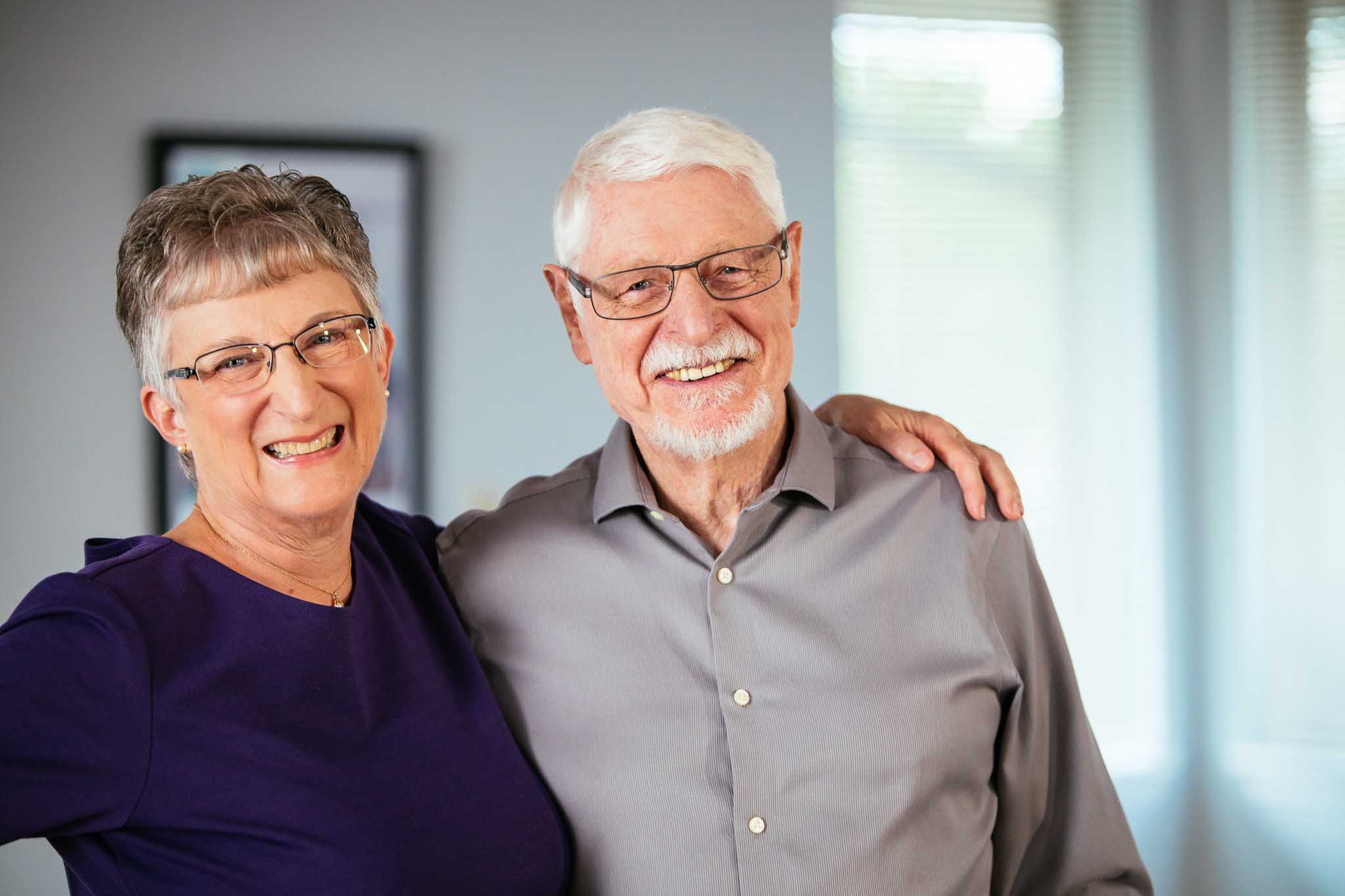 Smiling elderly couple posing together indoors
