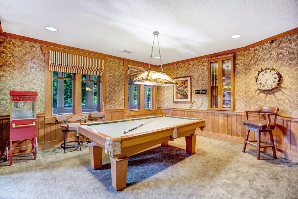 A bright billiards room with a pool table and decor