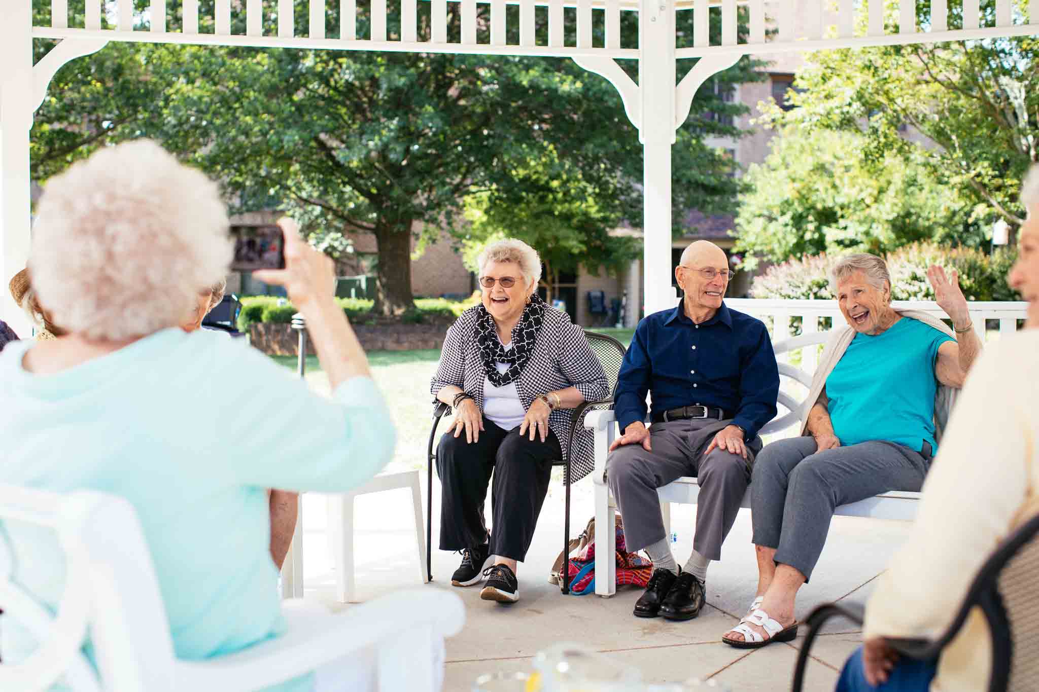Residents enjoying an outdoor gathering under a gazebo