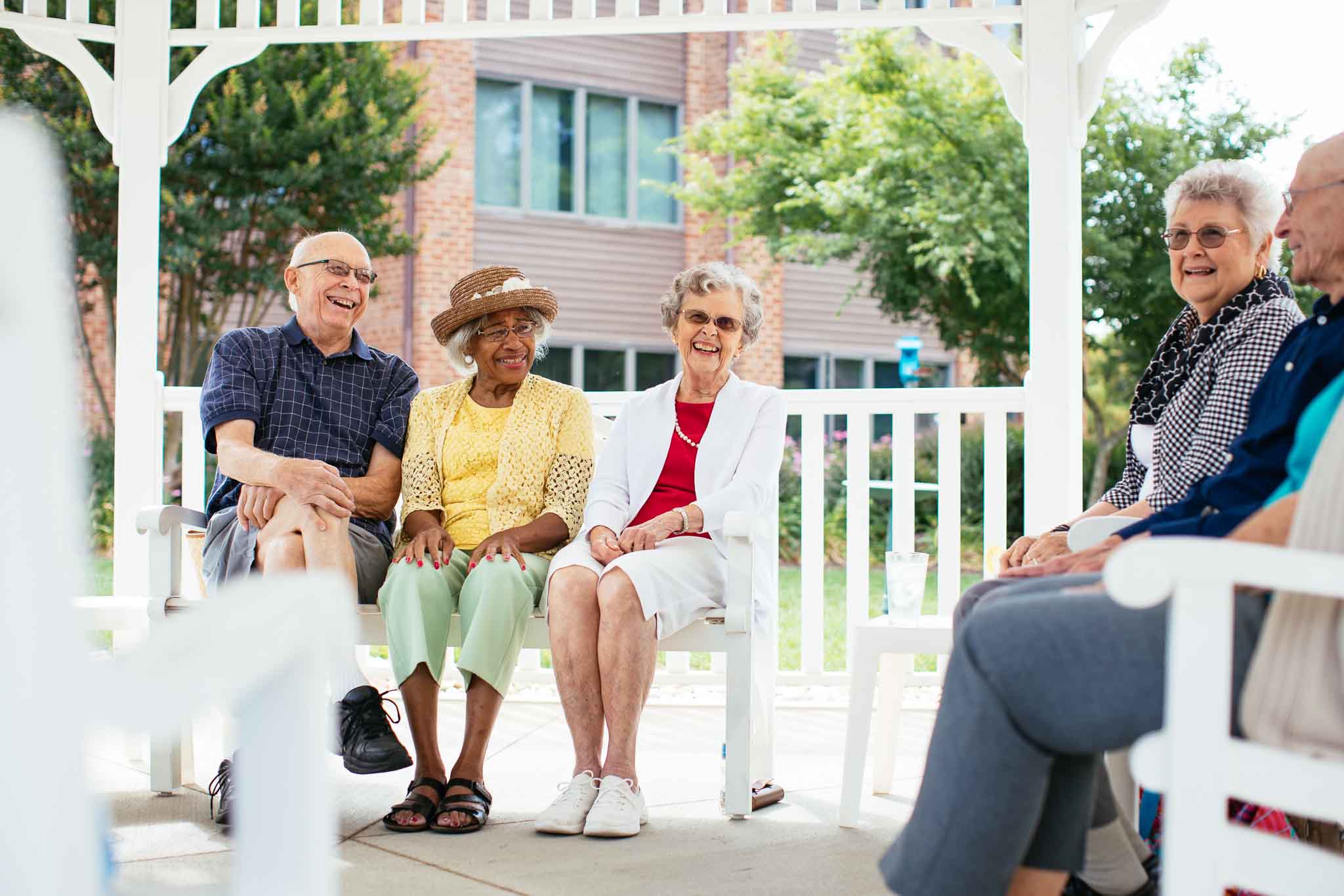 Residents enjoying conversation in an outdoor pavilion