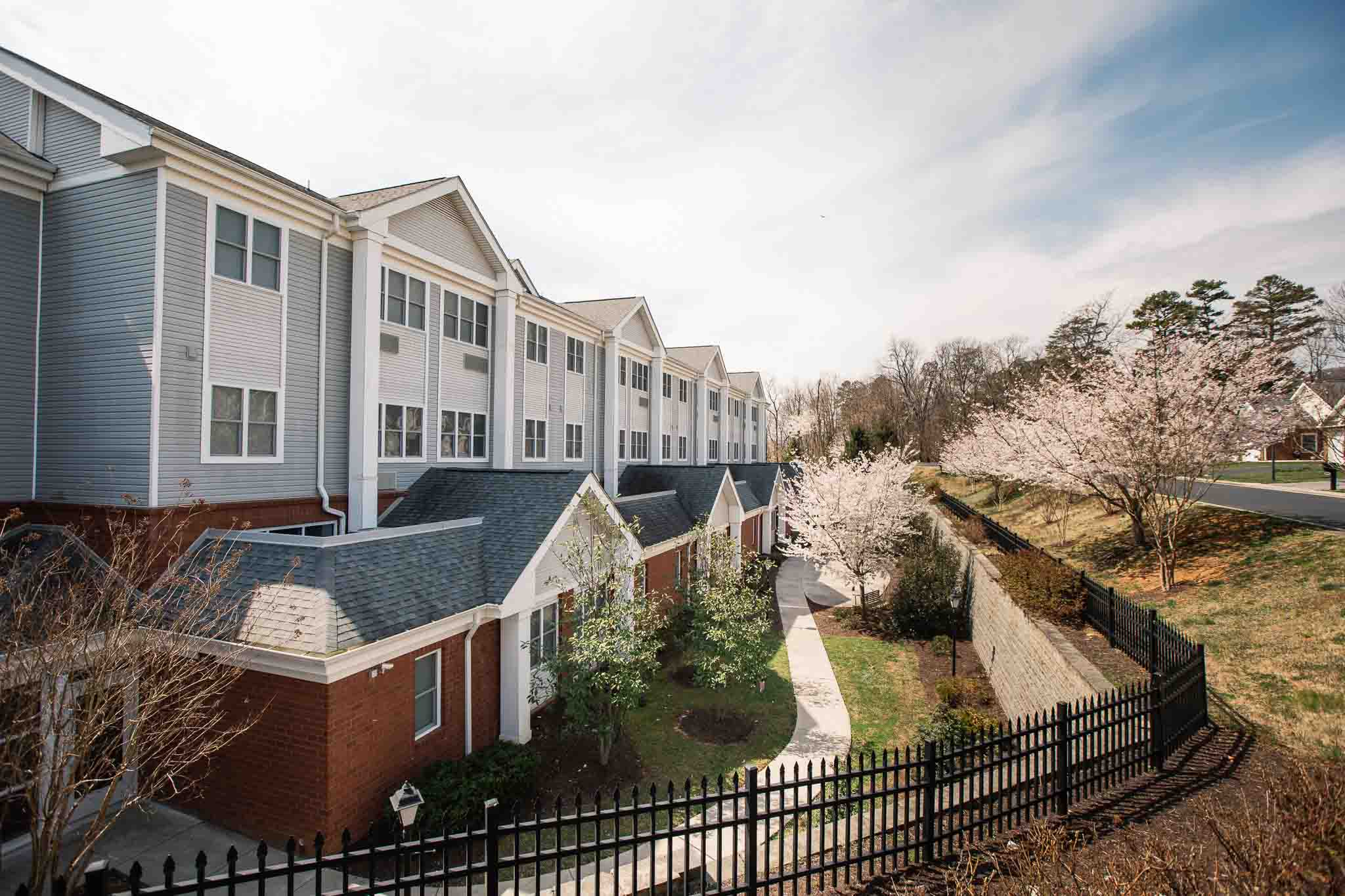 Exterior view of the facility with flowering trees