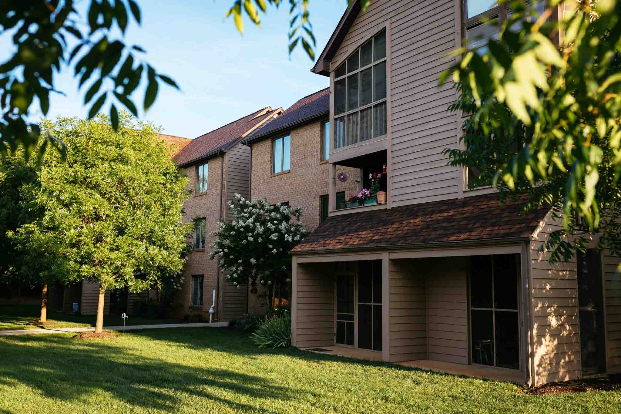 Exterior view of a senior living building with trees