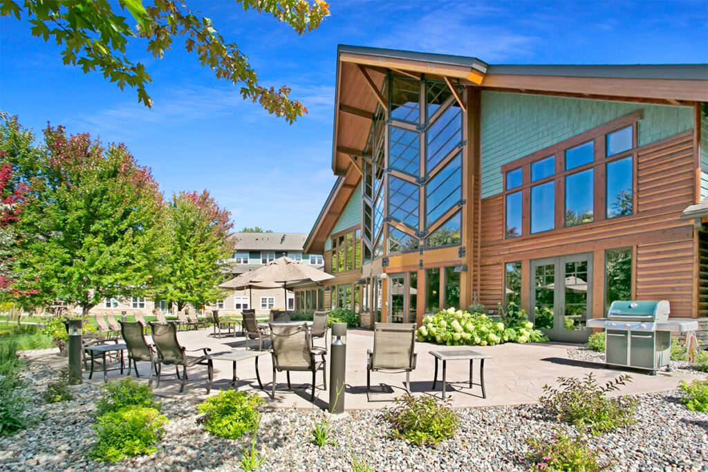 Exterior view of a modern assisted living facility with outdoor seating