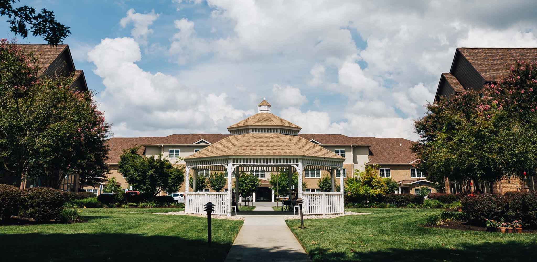 Outdoor gazebo surrounded by greenery and buildings