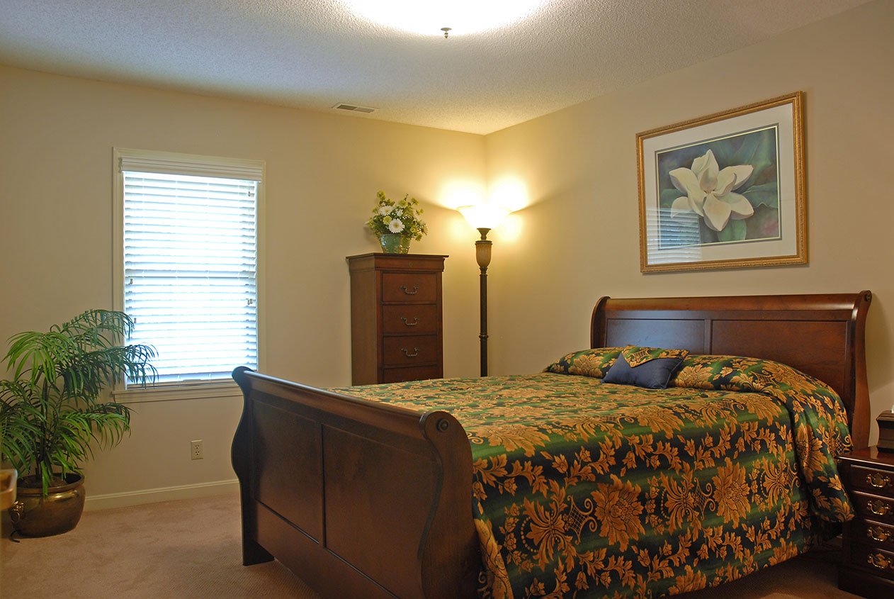 Cozy bedroom with floral bedding and furniture