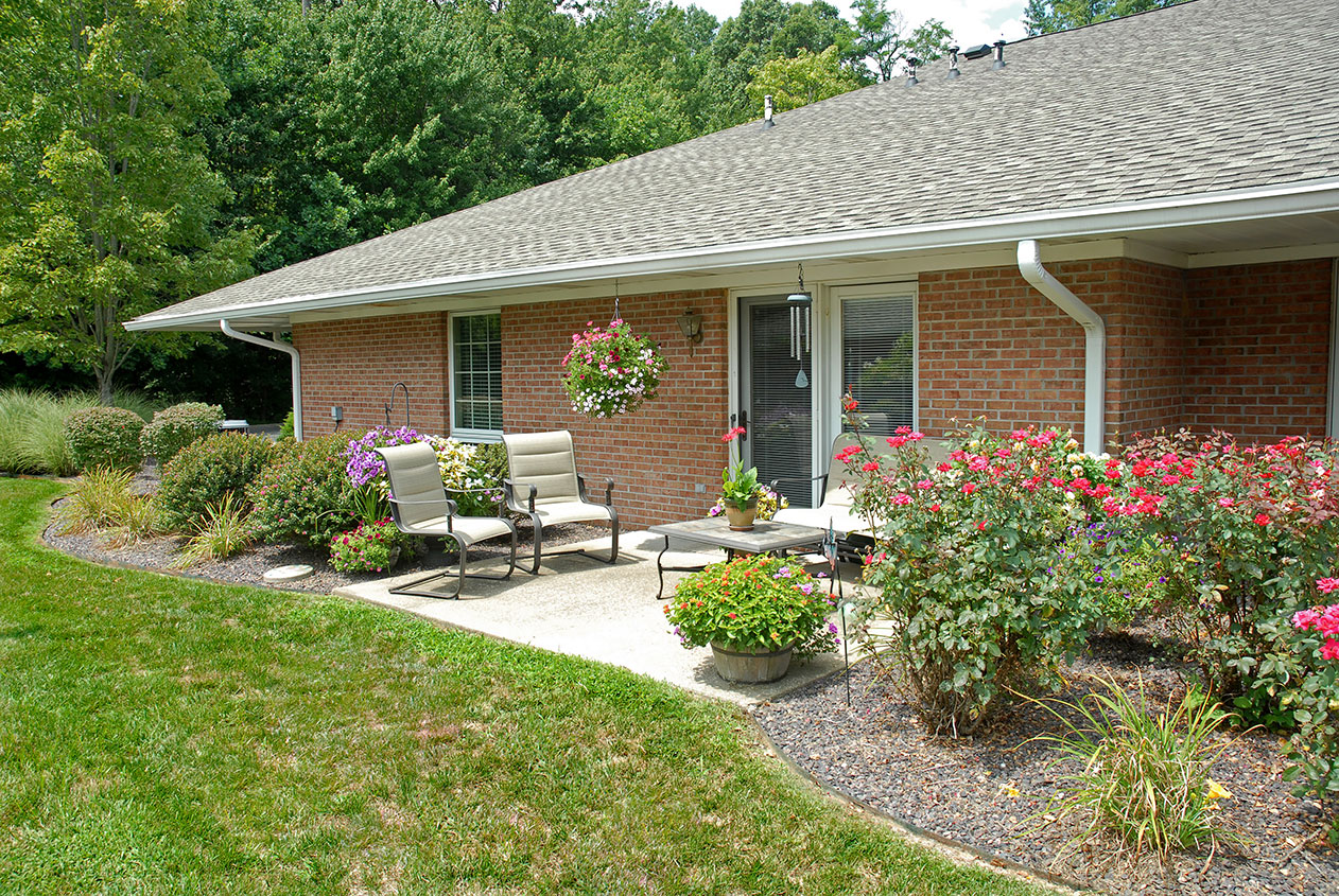 Outdoor seating area with flowers and greenery