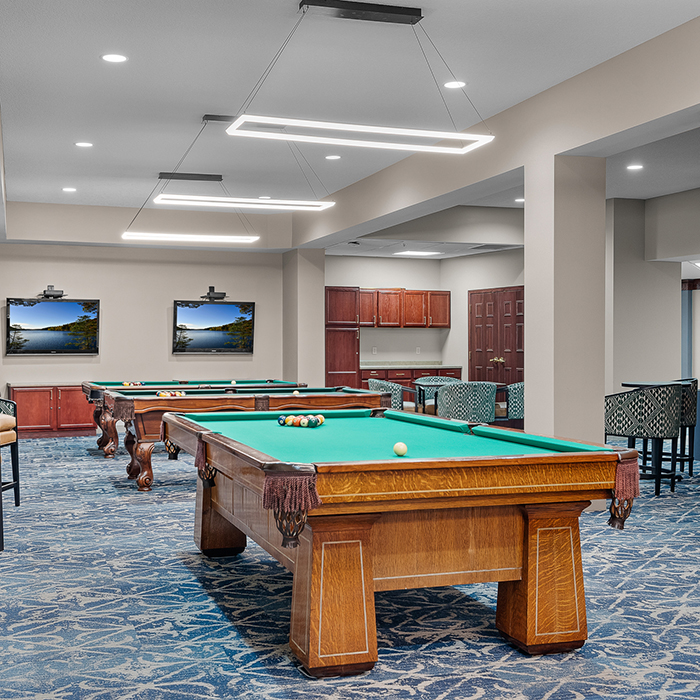 Bright activity room with pool tables and seating