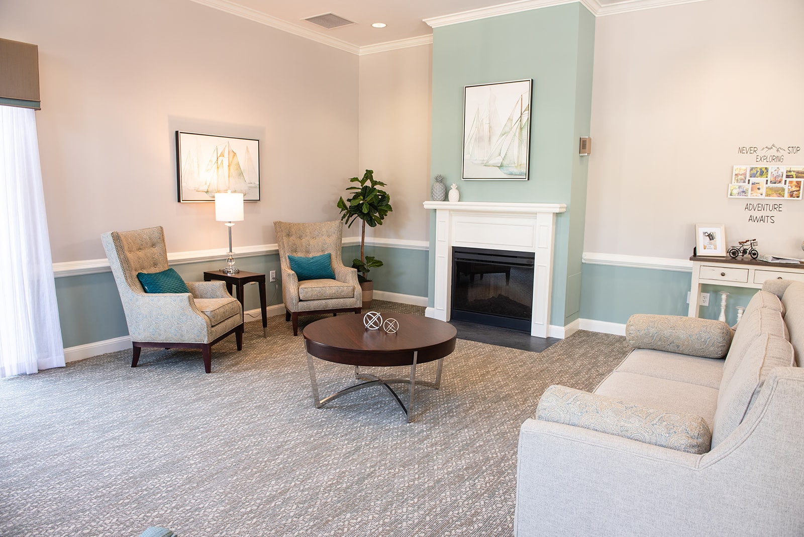 Bright common area with seating and fireplace