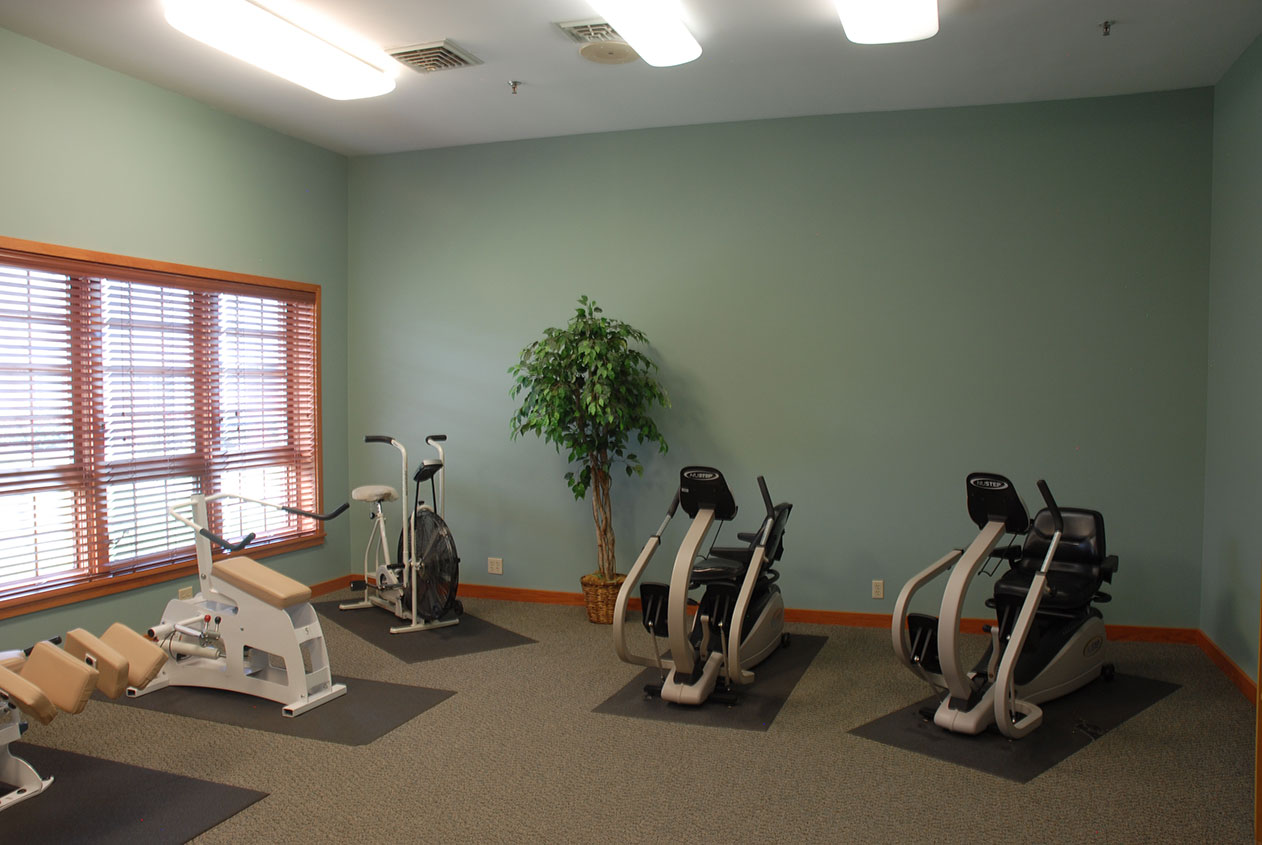 Fitness equipment in a well-lit exercise room