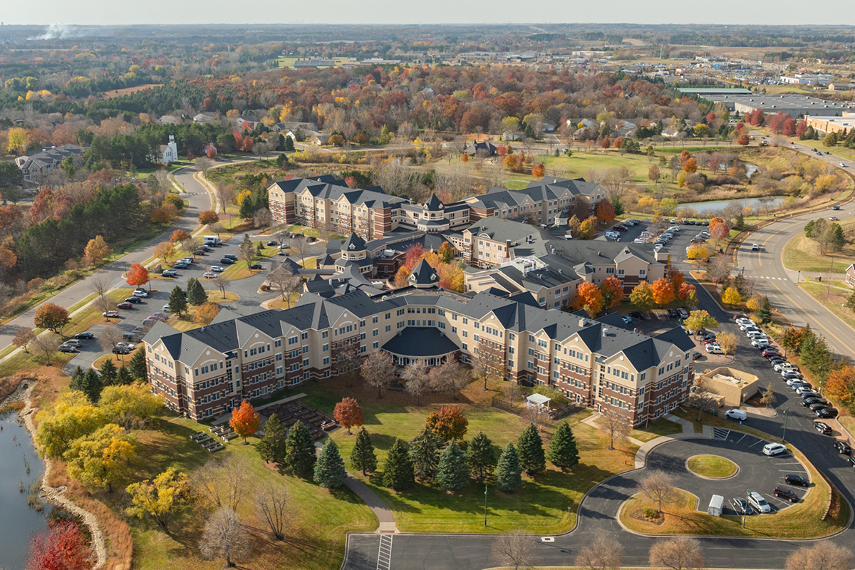 Aerial view of assisted living facility surrounded by trees