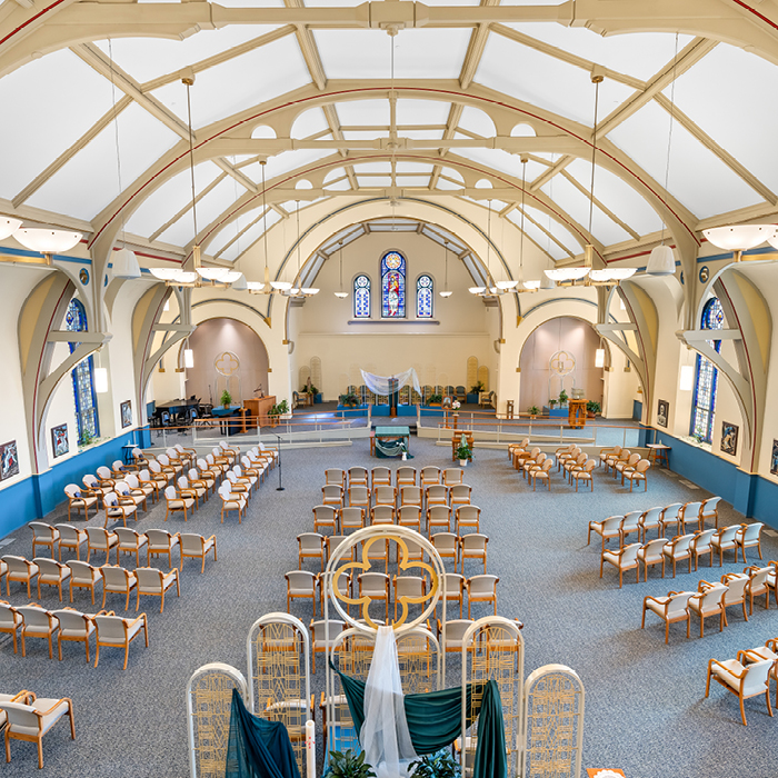 Interior of a spacious chapel with wooden chairs
