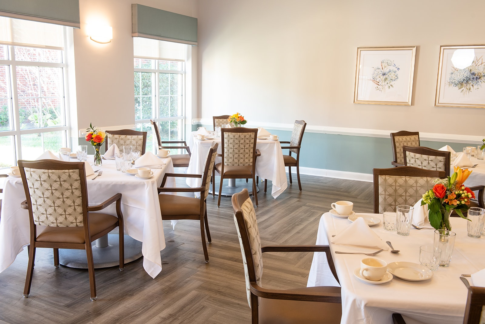 Dining room setup with floral centerpieces