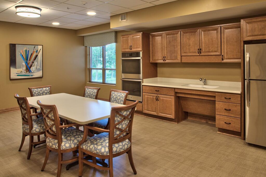Bright common area with a dining table and kitchen