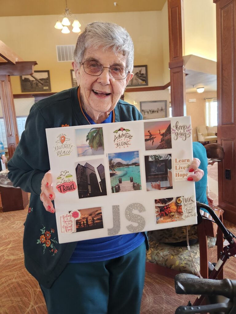 Resident holding a memory collage in a common area