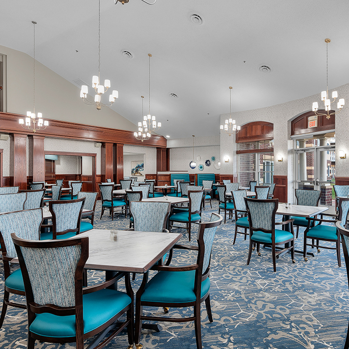 Dining room with teal chairs and elegant lighting