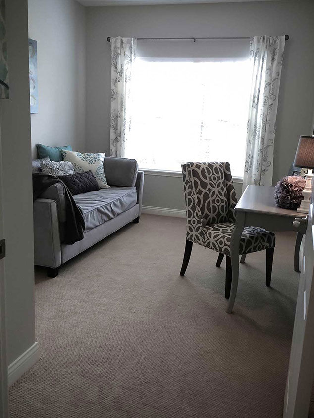Cozy private resident room with a couch and desk