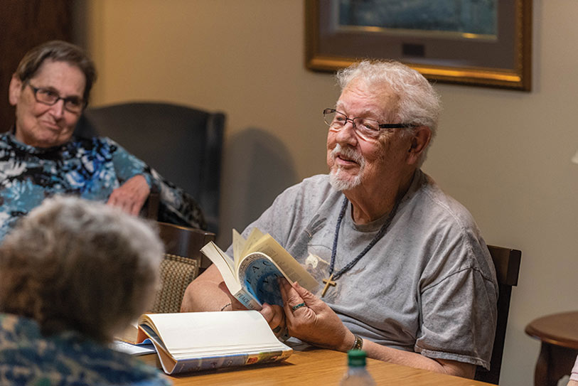 Residents reading and engaging in conversation in a common area