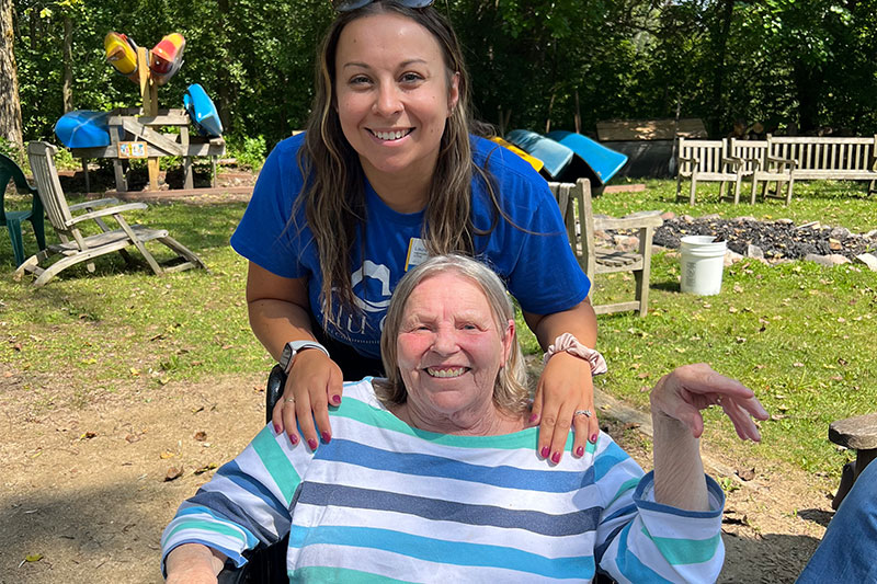 Staff member with resident in a garden space