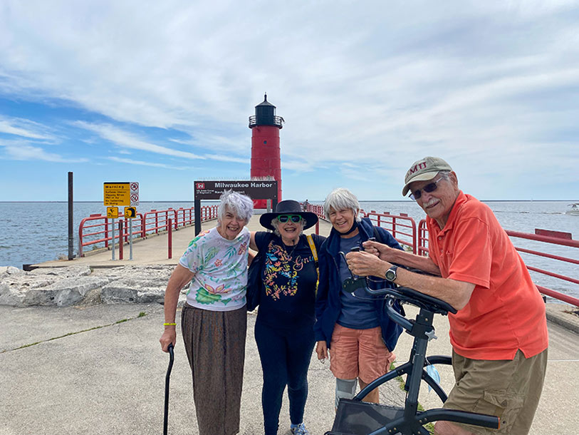 Four residents enjoying a sunny day at the harbor