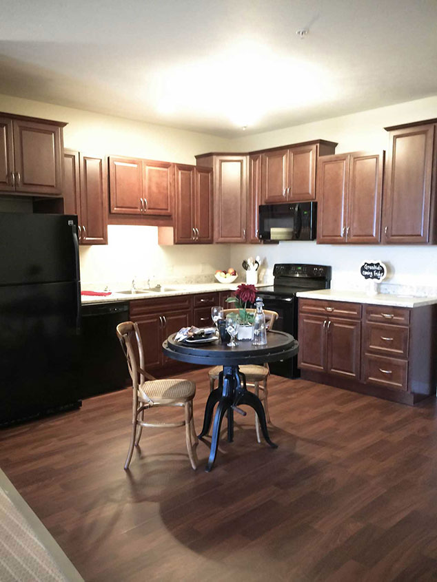 A cozy kitchen area with wooden cabinets and a table