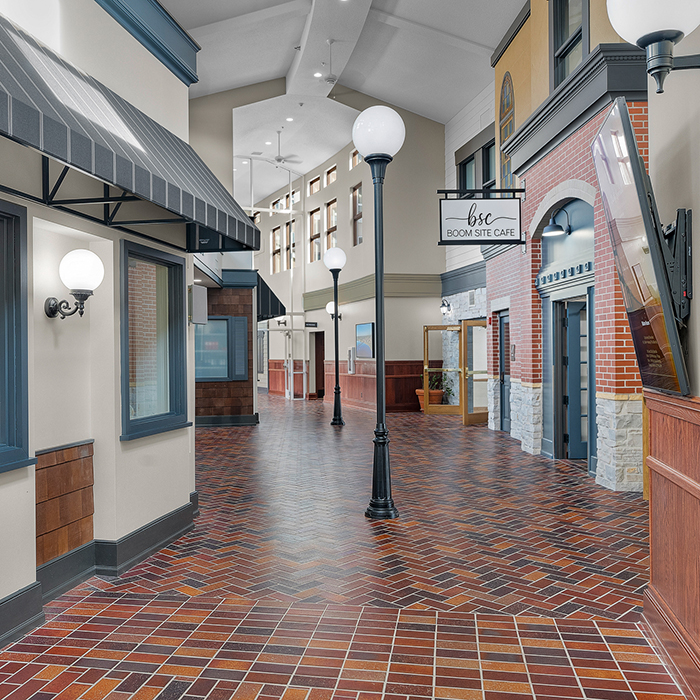 Interior hallway of a senior living facility with café sign