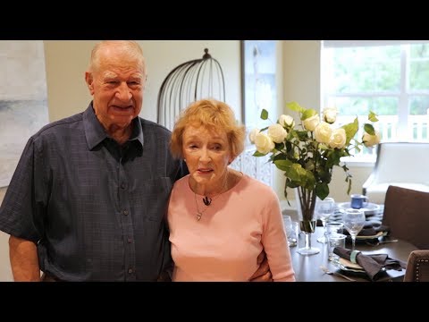 Two residents standing together in a dining area