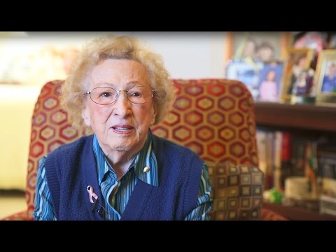 Resident sharing her experience in a cozy common area