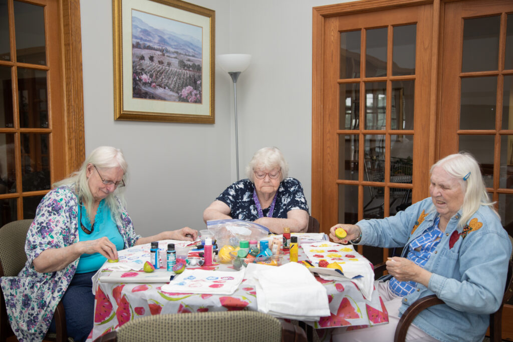 Residents engaged in an art activity in a common area
