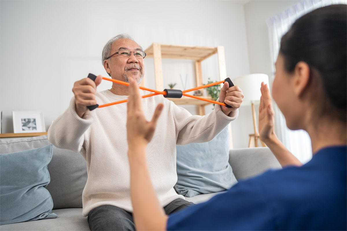 Therapy session with an elderly man and staff member