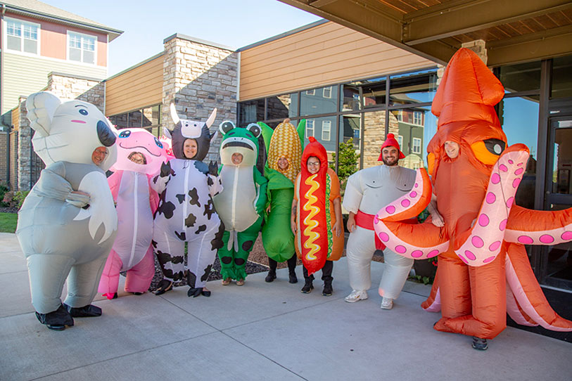Staff in fun costumes outside the building