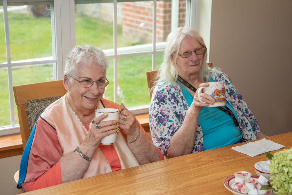Two residents enjoying drinks at a table