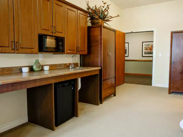 Interior view of a private resident room with kitchenette