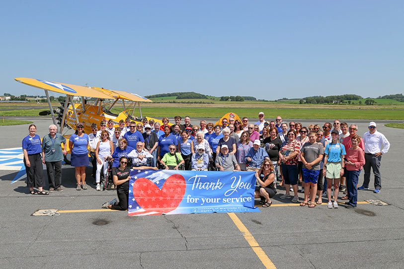 Group of people holding a banner at an outdoor event