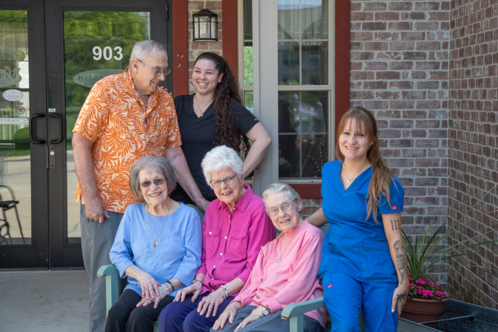 Residents and staff posing together outside