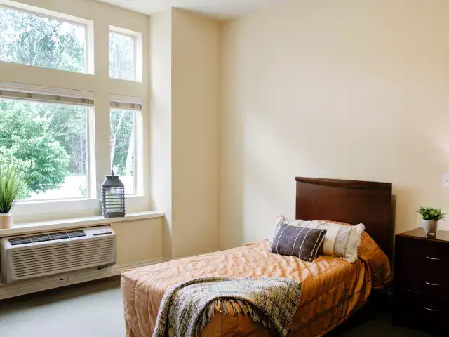 Cozy private room with bed and window view
