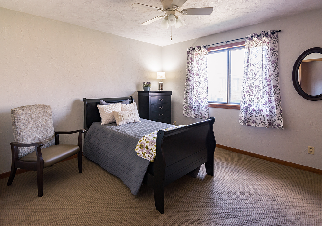 Cozy resident room with a bed and chair