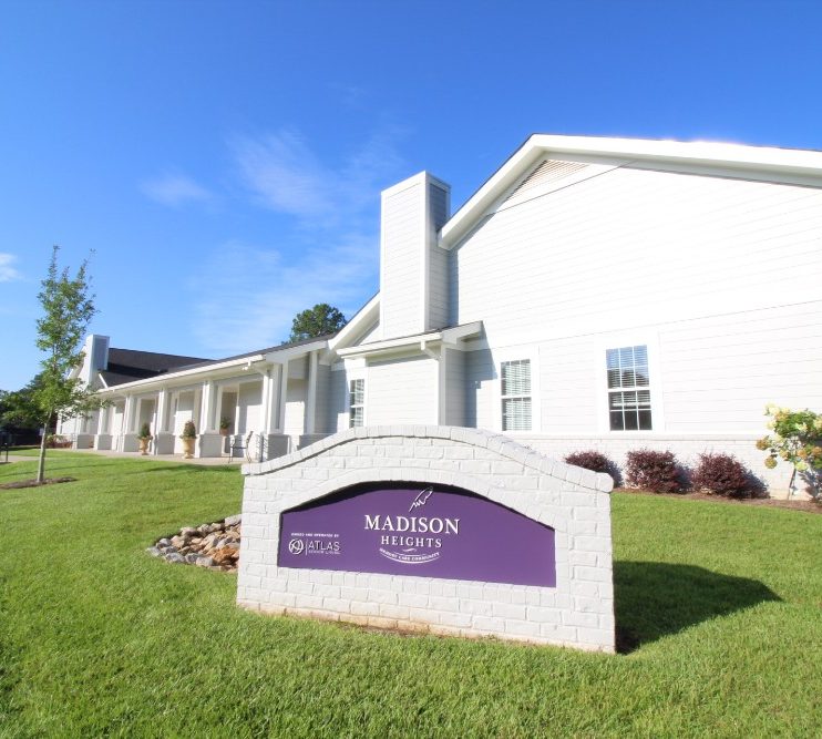 Exterior view of a senior living facility's sign and building