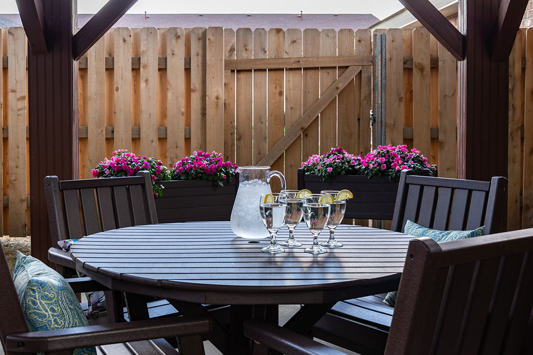 Outdoor dining area with a table and flowers