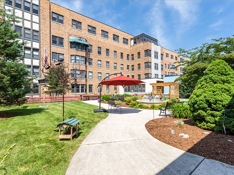 Outdoor seating area with landscaping near the facility