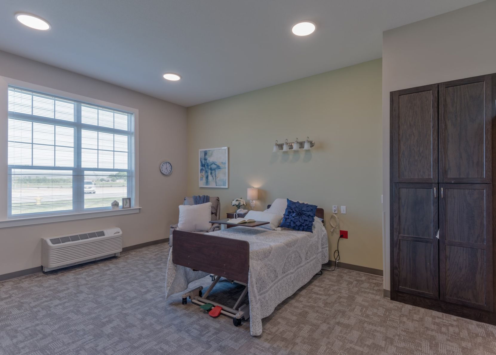 Bright resident room with a bed and decor