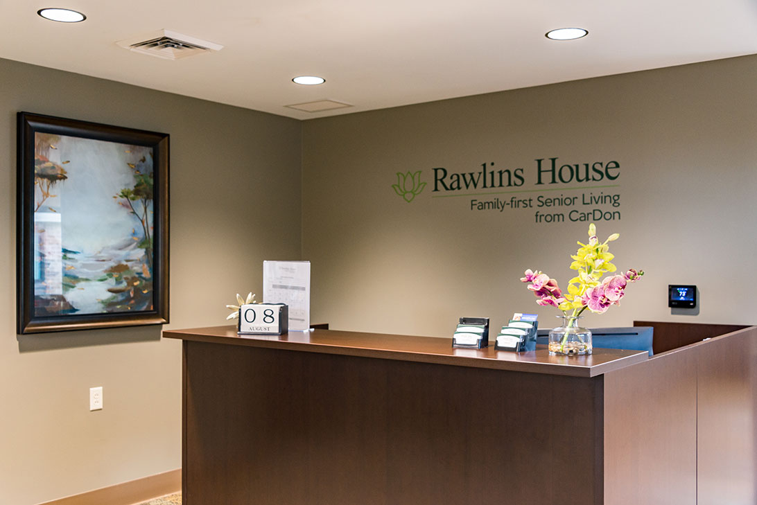 Reception area with floral decor and welcoming sign