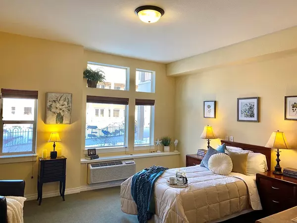 A bright resident room with natural light and cozy decor