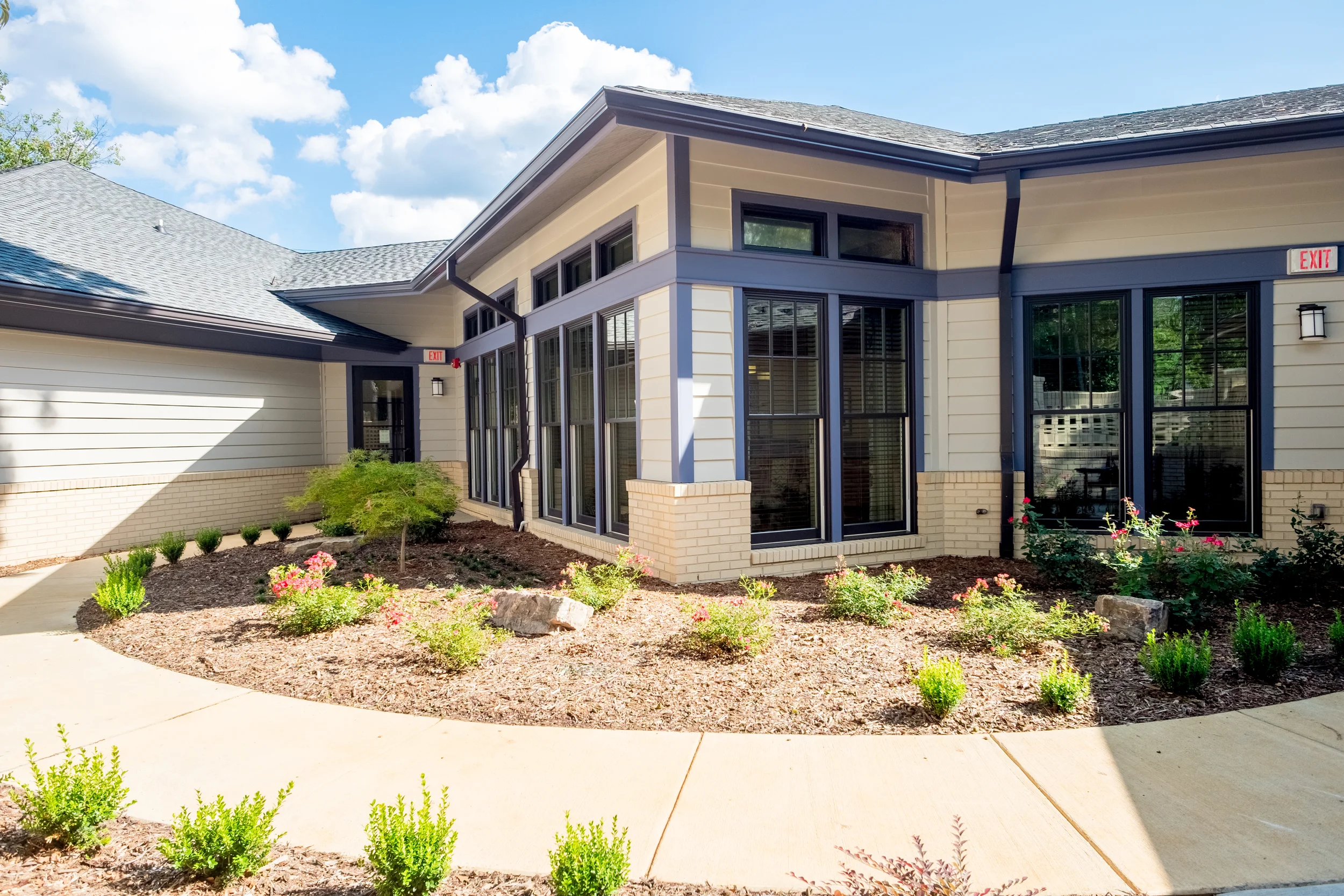 Exterior view of the facility with garden landscaping.
