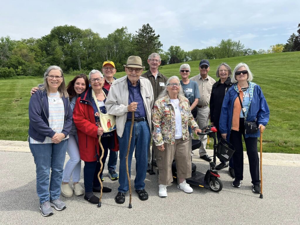 Group of residents posing outdoors in a cheerful setting