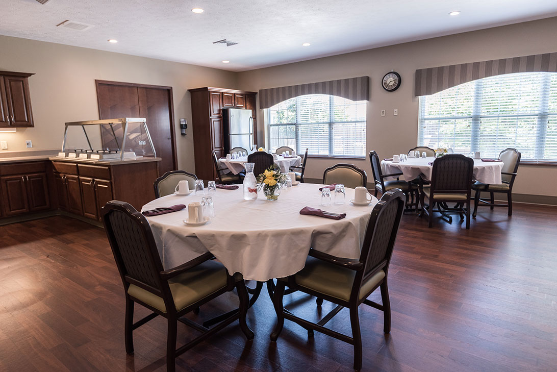 Dining area set up for a meal with tables and chairs