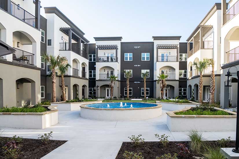 Courtyard with a fountain and surrounding apartments